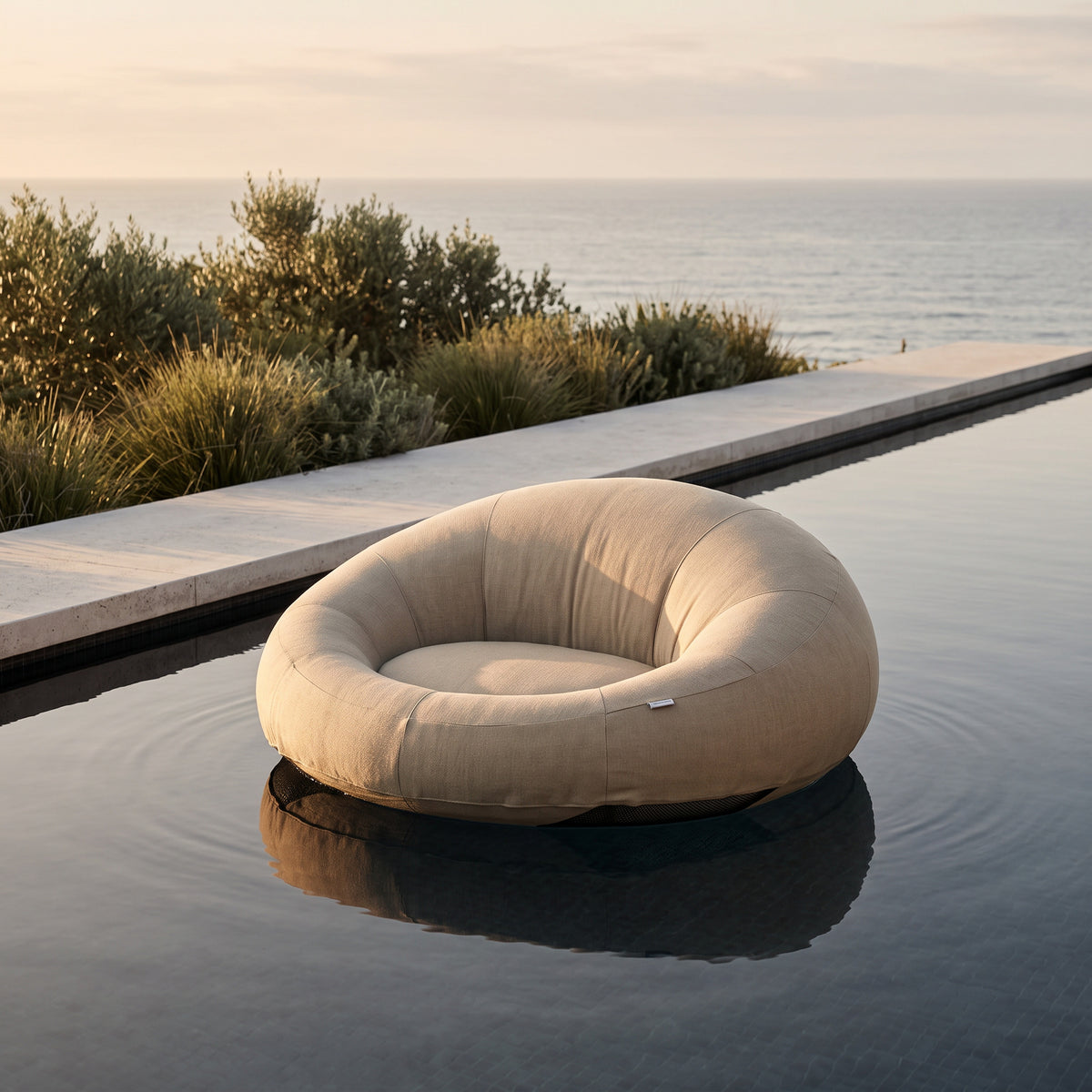 Poolboy Floata-Round in Natural beige on the water.