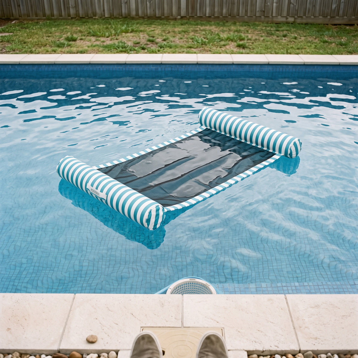 Poolboy Sinka-Bit in Blue and White stripe on the water.
