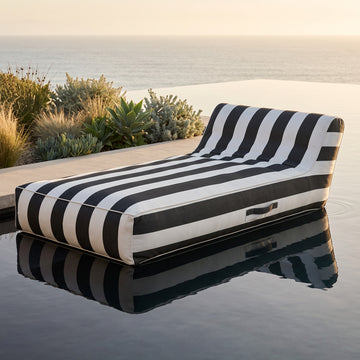 Poolboy Floata-Long in Black and White stripe on the water.