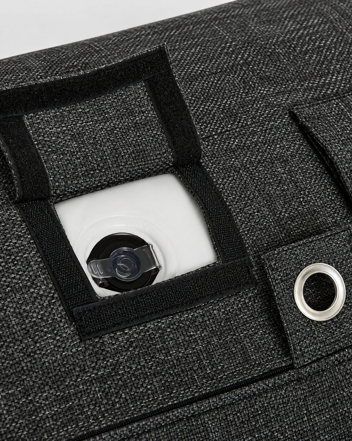 The recessed inflation valve under its flap